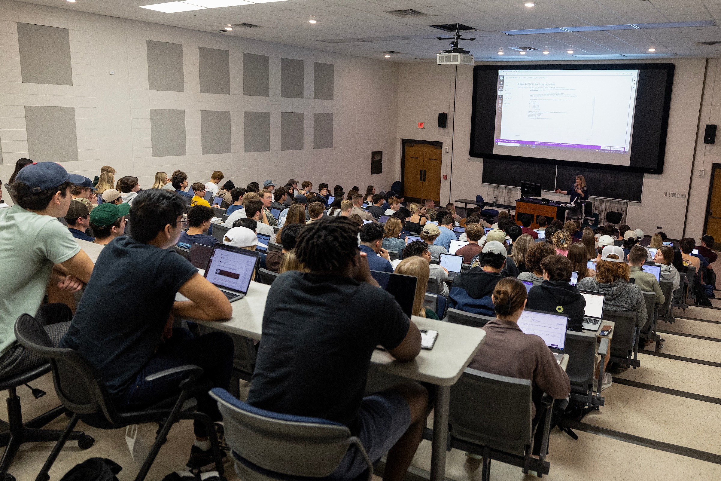 Faculty member in the front of a classroom that is full of students